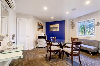 A dining room with a table and chairs and a living room